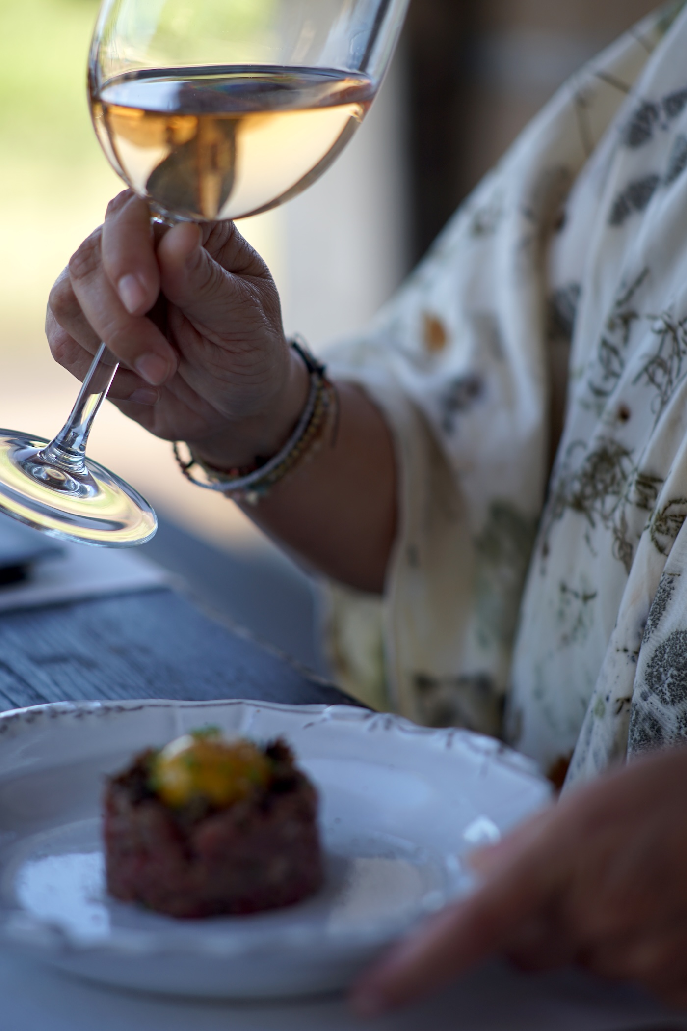 Participant enjoying wine and steak tar tar at Anatolias during a Mutiny Retreat